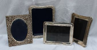 A continental white metal photograph frame of rectangular form embossed with flowerheads and leaves,