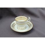 A Swansea porcelain coffee cup and saucer, decorated in the so called "Olympic Rings"pattern,