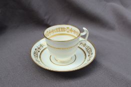 A Swansea porcelain coffee cup and saucer, decorated in the so called "Olympic Rings"pattern,