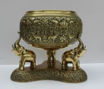 An Anglo Indian bronze bowl cast with elephants, leaves, and animals,