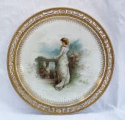 A Minton porcelain cabinet plate painted with a lady on a terrace overlooking a lake with hills in