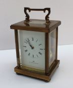 A Matthew Norman carriage clock with a brass case, the enamel dial with Roman numerals inscribed,