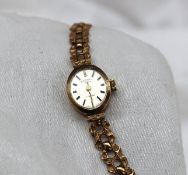 A 9ct yellow gold lady's Rotary wristwatch, together with a yellow metal bar brooch,