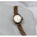 A 9ct yellow gold lady's Rotary wristwatch, together with a yellow metal bar brooch,