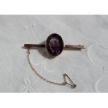 A 9ct yellow gold bar brooch set with a large oval faceted amethyst