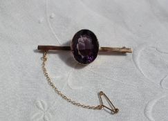 A 9ct yellow gold bar brooch set with a large oval faceted amethyst