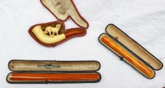 A yellow metal mounted amber cheroot holder (cased) together with a meerschaum pipe in the form of