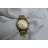 A Gentleman's 9ct yellow gold Garrard wristwatch, with a silvered dial,