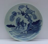A late 18th century/ early 19th century Chinese blue and white bowl decorated with a dog of foo in a