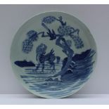 A late 18th century/ early 19th century Chinese blue and white bowl decorated with a dog of foo in a