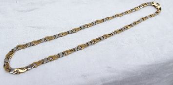 A 9ct yellow and white gold necklace with "S" links, approximately 20.
