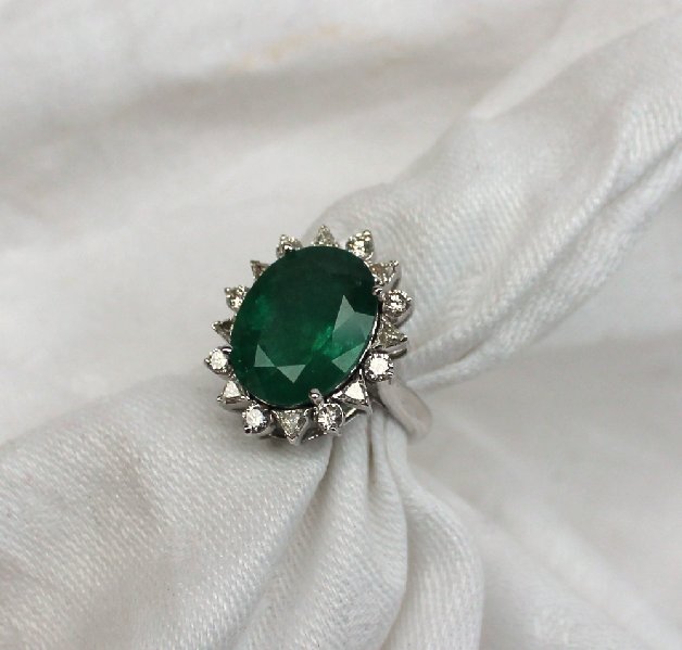 An emerald and diamond ring the central oval faceted emerald measuring 17mm x 13mm surrounded by - Image 3 of 4