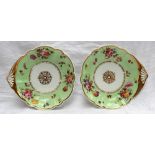 A pair of Swansea porcelain shell dishes with gilt rim and centre painted with sprays of garden