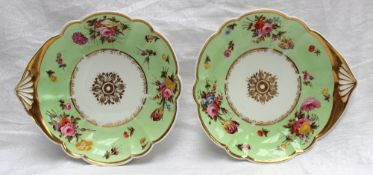 A pair of Swansea porcelain shell dishes with gilt rim and centre painted with sprays of garden