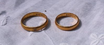 Two 22ct yellow gold wedding bands approximately 10 grams together with two yellow metal wedding