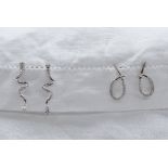 A pair of 18ct white gold earrings set with diamonds to a hoop setting,