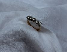 A five stone diamond ring set with old cut diamonds totalling approximately 1 carat,