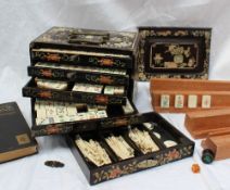 A bone and bamboo Mah Jong set contained within an inlaid five drawer chest,