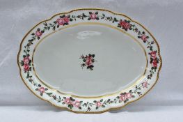 A Nantgarw porcelain oval dish painted with a single rose to the centre, garlands of roses in the