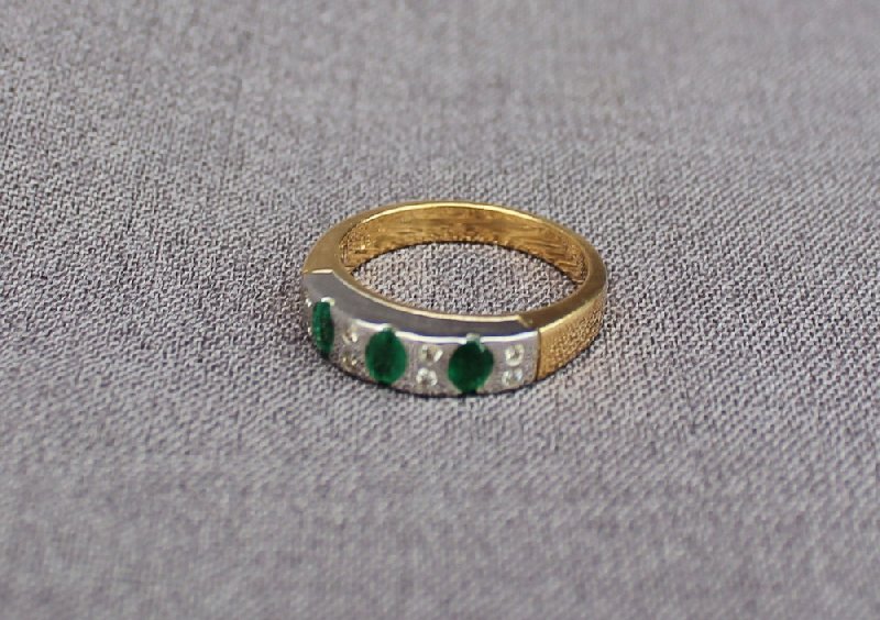 An Emerald and diamond ring set with three oval emeralds and eight brilliant cut diamonds to a - Image 2 of 4
