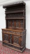 A 19th century oak dresser profusely carved with stars, leaves and arches,
