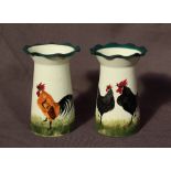 A pair of Wemyss ware pottery flared vases decorated with a black cockerel and hen to the one and