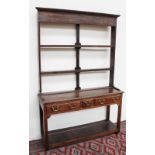 An 18th century style South Wales dresser, the open rack with a moulded cornice above two shelves,