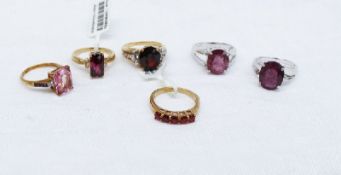 A 9ct yellow gold ruby line ring together with a garnet and topaz ring and a collection of 9ct