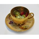 A Royal Worcester porcelain cabinet tea cup and saucer painted with gooseberries, raspberries apples