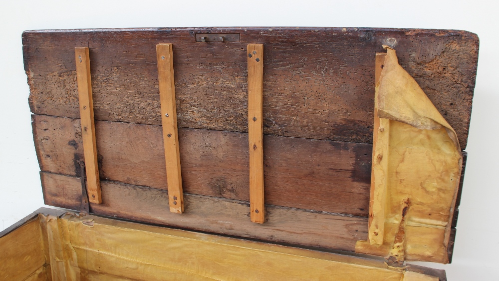 An 18th century oak coffer, the planked rectangular top above a four panel front on stiles, - Image 3 of 5