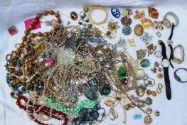 Assorted costume jewellery including brooches, pendants, chains, earrings, bracelets, watches,
