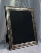 An Elizabeth II silver photograph frame with a bead decorated edge, 32 x 26.