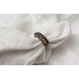 A diamond set dress ring set with two rows of eight graduated old cut diamonds to a yellow metal