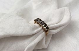 A diamond set dress ring set with two rows of eight graduated old cut diamonds to a yellow metal