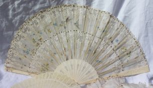 A bone and lace fan painted with birds and leaves with carved and pierced sticks,