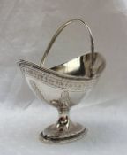 A Victorian  silver swing handled pointed oval pedestal sugar basket, with a gilt interior,