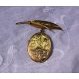 A 9ct yellow gold locket of oval form decorated with leaves on a leaf clasp,