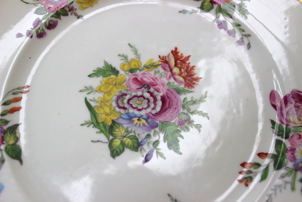 A 19th century porcelain plate painted with sprays of garden flowers within a gilt border, gilt - Image 2 of 3