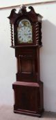 A 19th century mahogany longcase clock the hood with a central carved grapes and vine panel and