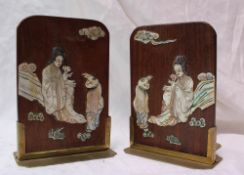 A pair of Japanese mother of pearl inlaid bookends decorated with figures in a landscape on folding