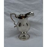 An Elizabeth II silver pedestal cream jug,