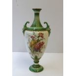 A Royal Worcester twin handled vase of ovoid shape with green ground, gilt lined fluted narrow
