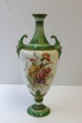 A Royal Worcester twin handled vase of ovoid shape with green ground, gilt lined fluted narrow