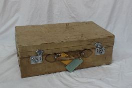 A leather suitcase with a corduroy lined section and removable tray,