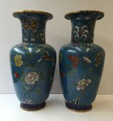 A pair of Japanese cloisonne baluster vases decorated with birds and insects amongst flowers to a