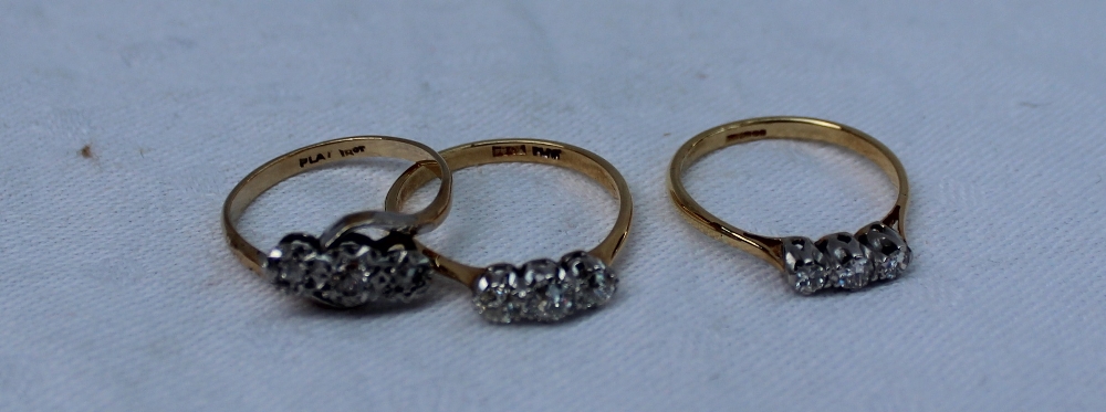 A three stone diamond ring set with graduated old cut diamonds to a white metal claw setting and a - Image 2 of 2