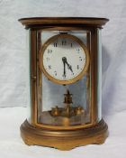 A late 19th / early 20th century oval brass cased four glass anniversary clock,