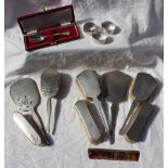 A George V silver backed part dressing table set comprising two hair brushes,