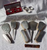 A George V silver backed part dressing table set comprising two hair brushes,
