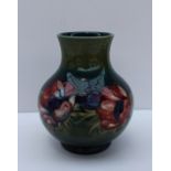 A Moorcroft pottery vase decorated in the Anemone pattern to a graded green ground, 19.5cm high,